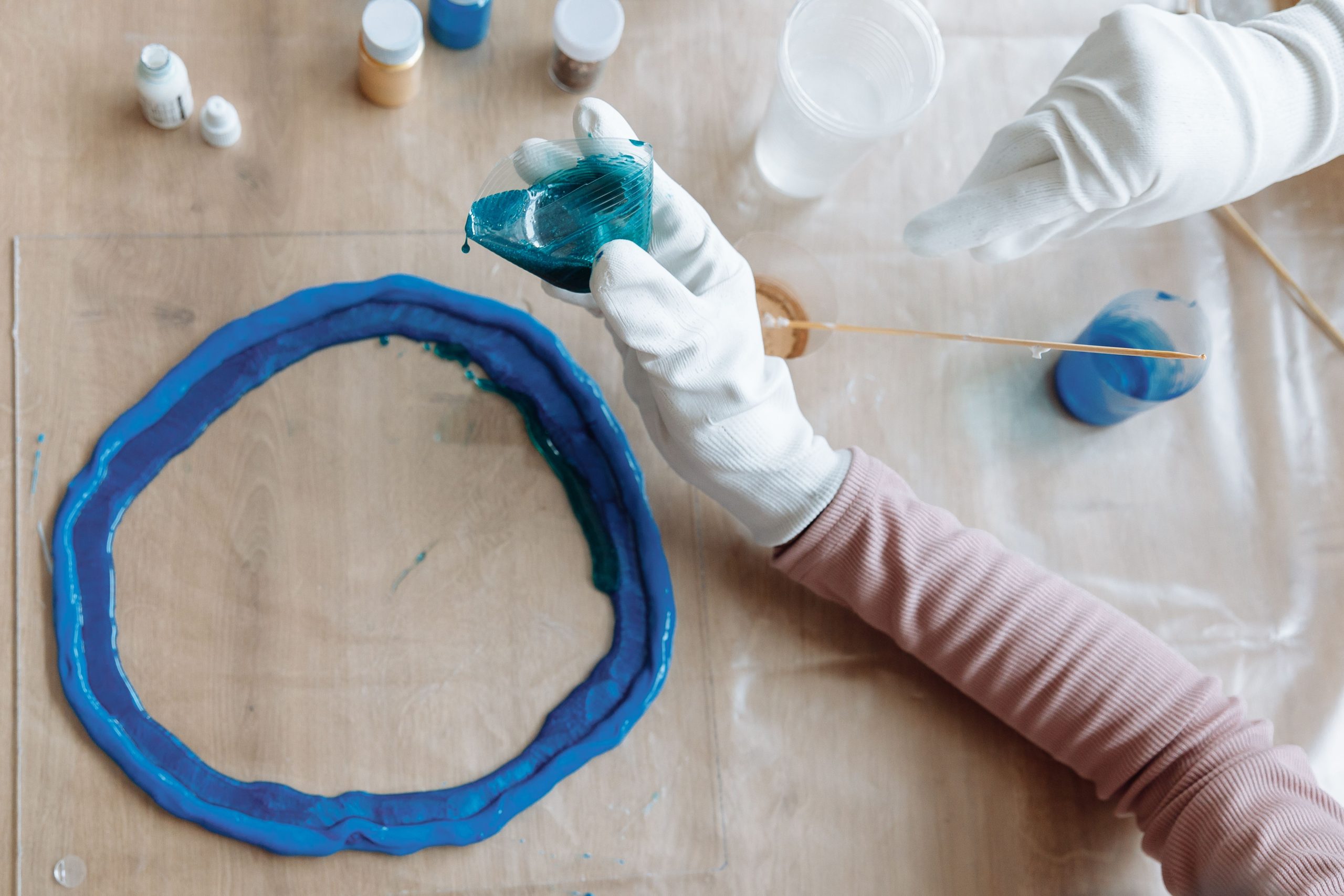 Mains façonnant art résine bleue en atelier