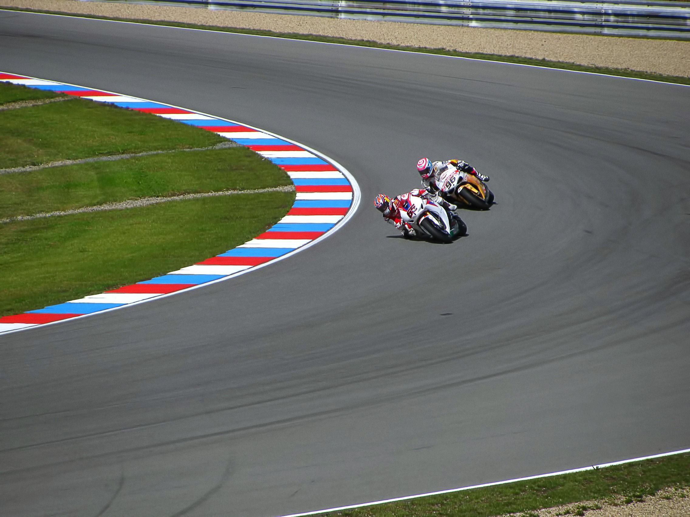 Deux coureurs Ducati sur piste colorée virée